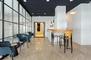 a bar in a room with chairs and a table at Feelathome Waldorf Suites Apartments in Madrid