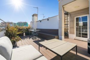 a patio with a table and chairs on a balcony at Feelathome Waldorf Suites Apartments in Madrid +39 photos