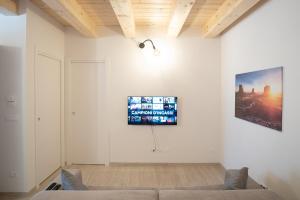 a living room with a couch and a tv on the wall at HouseImperia in Imperia
