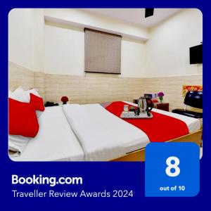 a hotel room with two beds with red and white sheets at Super OYO Hotel Tourist Residency in Jaipur