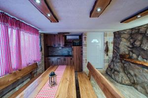 Zimmer mit einem Holztisch und einer Felswand in der Unterkunft Apartman M&S s bazenom in Podstrana