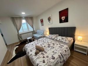 a bedroom with a bed and a chair at Kaštanová 27 in Olomouc
