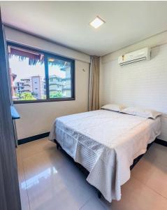 a bedroom with a large bed and a window at Manhattan Beach Riviera Aquiraz in Aquiraz