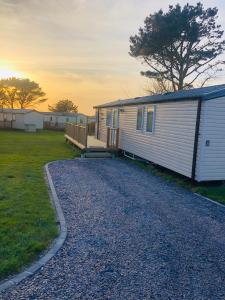 a mobile home is parked on a gravel road at B47 Caravan Seven Bays in Padstow