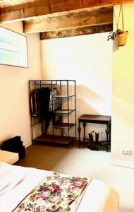 a bedroom with a bed and a rack of clothes at Vijfhoek Haarlem Studio Vlaming in Haarlem