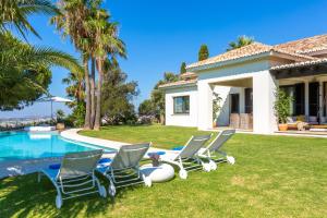a villa with a swimming pool and lawnitures at LXR Villa with breathtaking views to the Mediterranean 4 HAB in Torremuelle +48 photos