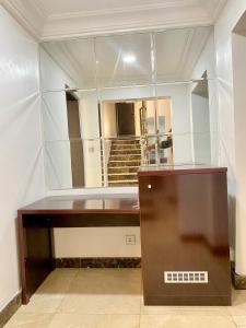 a dressing table in front of a mirror at GLOVIS LUXURY APARTMENT in Abuja