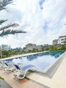 a swimming pool at a resort with lounge chairs at 2BEDROOM Condo for rent in Quezon City in Manila