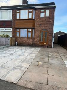 a brick house with a large driveway at Five Oaks House- Entire 3 Bedroom House for Family & Contractors with up to 5 sleep- NO PARTIES ALLOWED in Willenhall