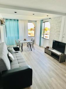 a living room with a couch and a table at Apartamento Castle Harbour in Los Cristianos