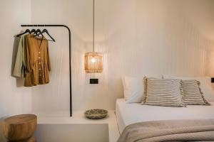 a bedroom with a bed and a lamp and a closet at Mystique Lagoon Villa in Argostoli