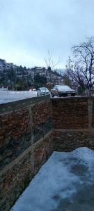 a brick retaining wall with snow on the ground at Ihram Hotel And Guest House in Swat