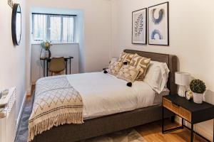 a bedroom with a bed and a table at The Liverpool Escape - Captivating 1BDR Flat in Liverpool