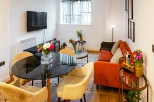 a living room with a table and a couch at The Liverpool Escape - Captivating 1BDR Flat in Liverpool