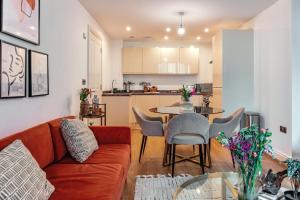 a living room with a couch and a table and a kitchen at The Liverpool Escape - Captivating 1BDR Flat in Liverpool