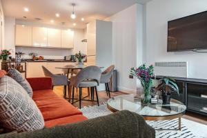 a living room with a couch and a table at The Liverpool Escape - Captivating 1BDR Flat in Liverpool