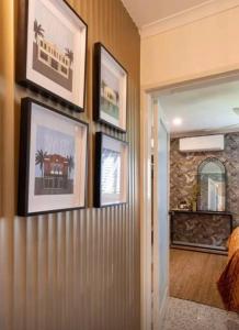 a hallway with pictures on the wall of a house at Gatsby Apartment@Mackay 