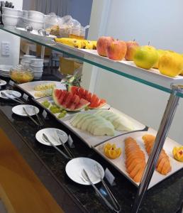 a buffet line with different types of fruits and vegetables at Golden Hotel - O MAIS CENTRAL - Pet Friendly in Chapecó
