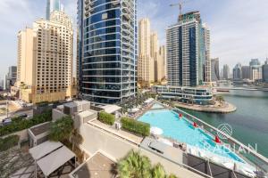 an aerial view of a city with a swimming pool at Exclusive Newly Renovated 1BR full Marina views in Dubai