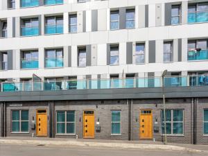 an office building with orange and yellow doors at Queens Lodge 1-Bed Apartment in Redhill in Redhill