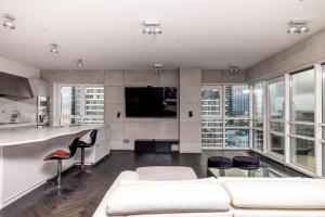 a living room with white furniture and large windows at Black Pearl - Amazing City View, 130 sqm in Warsaw