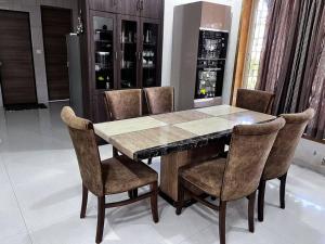 a dining room table and chairs in a room at D Villa : A posh bunglow with modern amenities in Panaji
