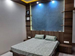 a bedroom with a bed with two pillows at D Villa : A posh bunglow with modern amenities in Panaji