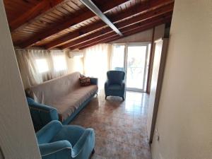 a living room with a couch and a chair at Dove Apart Hotel in Fethiye