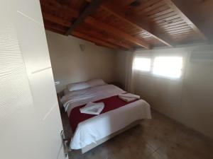 a small bedroom with two beds and a window at Dove Apart Hotel in Fethiye
