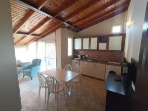 a kitchen and dining room with a table and chairs at Dove Apart Hotel in Fethiye