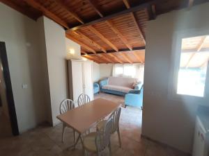a dining room with a table and chairs and a couch at Dove Apart Hotel in Fethiye