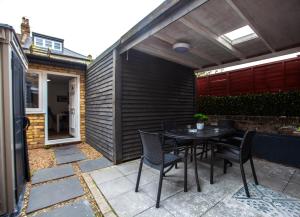 a patio with a table and chairs on it at The Finsbury Guesthouse in London