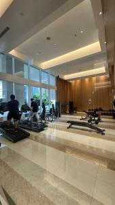a group of people doing pilates in a gym at Apartemen Podomoro View Kota 2BR lantai 17 Full perabot in Medan