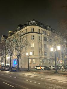 a large building on a city street at night at Motel Blue Messe in Berlin