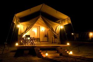 a large tent with lights in the night at NSYA CAMP MANYARA in Mto wa Mbu