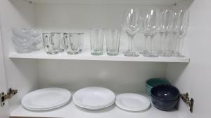 a shelf with wine glasses and plates on it at Mi corazon en San Telmo in Buenos Aires +41 photos