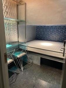 a room with a bed and two chairs in it at Diamond Capsule Hotel Amsterdam South in Amstelveen