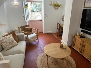 a living room with a couch and a table at La Recampado in Bormes-les-Mimosas