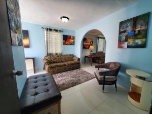 a living room with a couch and a chair at Chic 3 Bedroom Unit, Few Steps To The Ocean, Barbosa Unit 4 in Catano