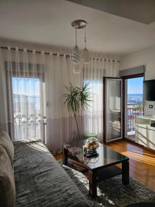 a living room with a couch and a table at Beki Apartment in Bar