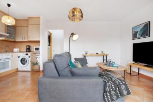 a living room with a blue couch and a table at Casa Vicente Majanicho in Lajares