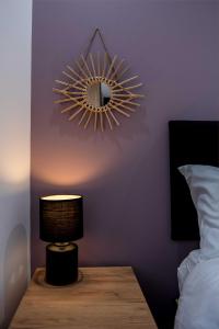 a bedroom with a mirror and a lamp on a table at Railway Apartments Rugby in Rugby