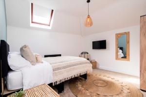 a bedroom with a white bed and a mirror at Railway Apartments Rugby in Rugby