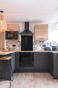 a kitchen with a black counter and a stove at Railway Apartments Rugby in Rugby