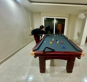 a man playing a game of pool on a table at HOTEL RANSAM in Āīzawl
