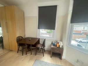 a dining room with a table and a window at Room with private bathroom and shared kitchen in London