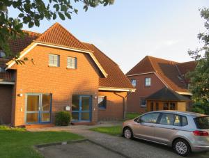a car parked in front of a house at Ferienwohnung Bartels in Petersdorf mit Terrasse in Fehmarn