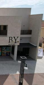 a building with arax sign on the side of it at חדרי בוטיק B.Y in Bet Sheʼan