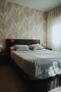 a bedroom with a large bed with a wall at Rosende VUT in Arzúa