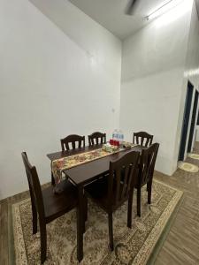 a dining room with a table and chairs at Seriemas Angler Venture Homestay in Sepang